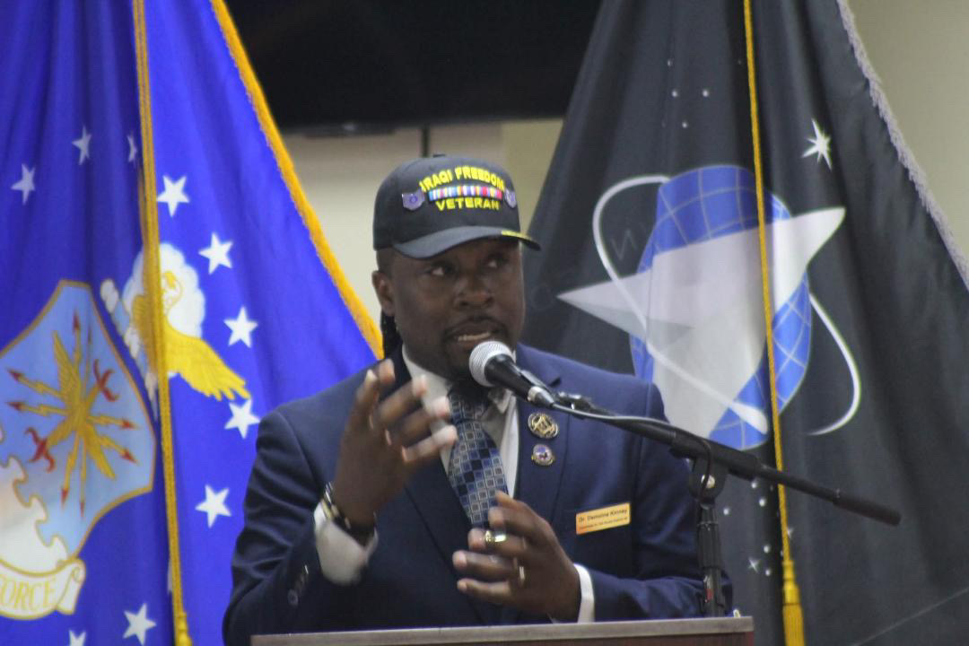 Dr. Demoine Kinney speaking at a military event