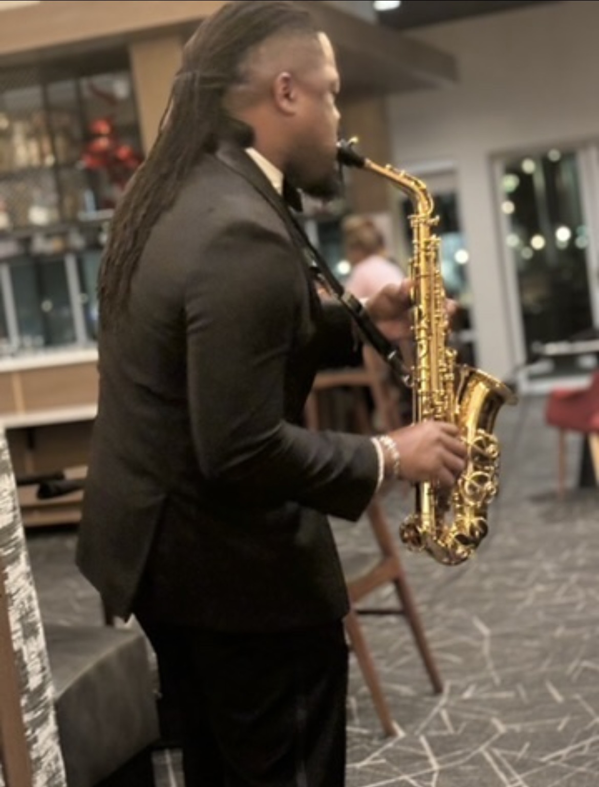 Dr. Demoine Kinney performing saxophone